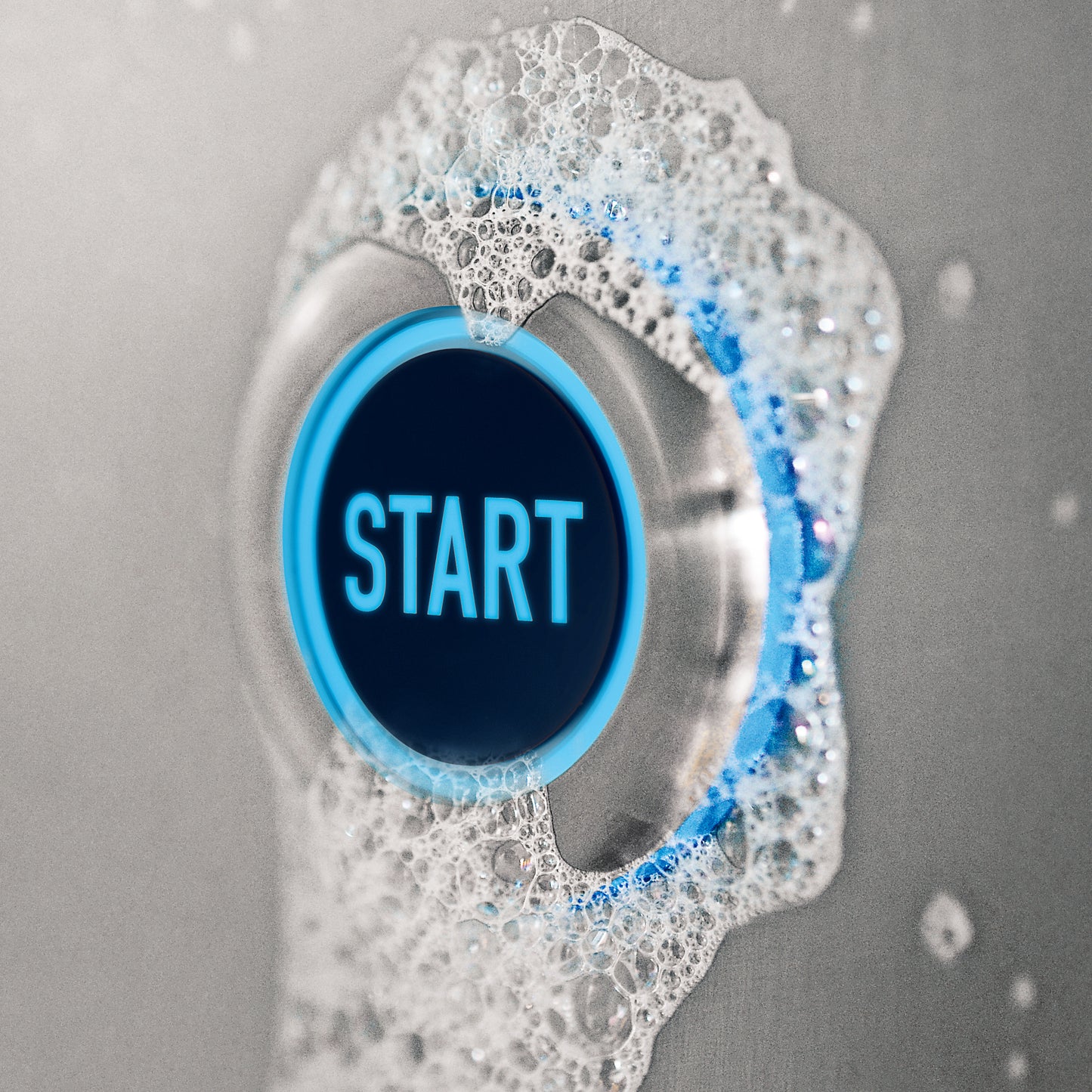 Button labeled 'START' with blue border surrounded by soap bubbles on a gray background