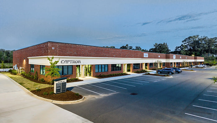 Commercial building with 'Captron' branding on a clear day