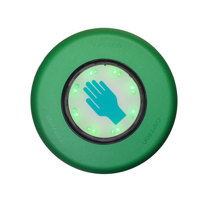 A green circular electronic device with a central illuminated panel showing a teal hand icon and small green LED lights, isolated on a white background.