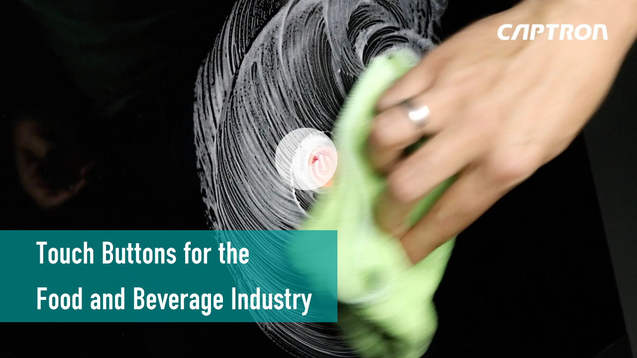 Load video: A hand wiping a touch button surface covered in suds